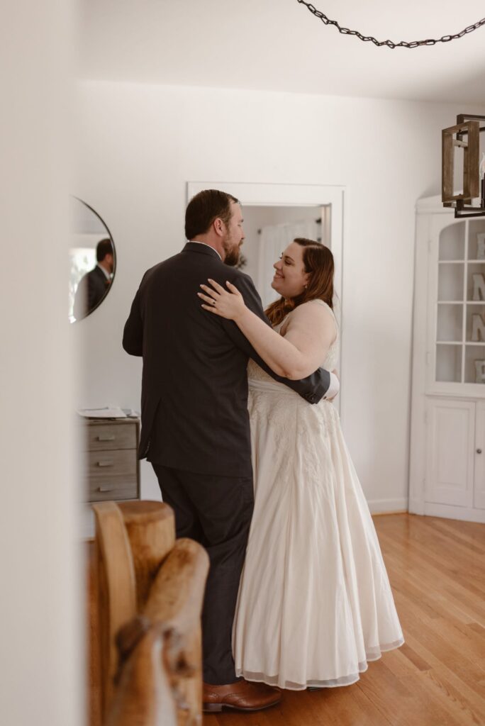 Couple shares spontaneous first dance in the living room on their wedding day