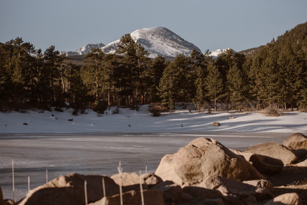 Frozen Copeland Lake in Allenspark Colorado with mountains in the distance