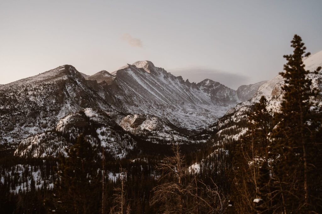 First light hitting the snowy mountains in Rocky Mountain National Park