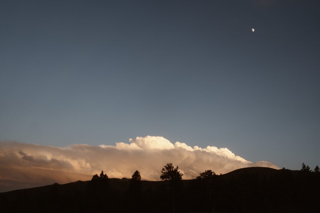 End of a June Colorado elopement with the moon out and dark blue sky