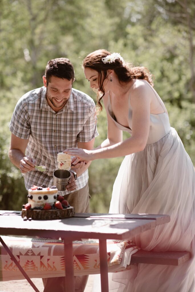 enjoying wedding cake at a campground in Rocky Mountain National Park