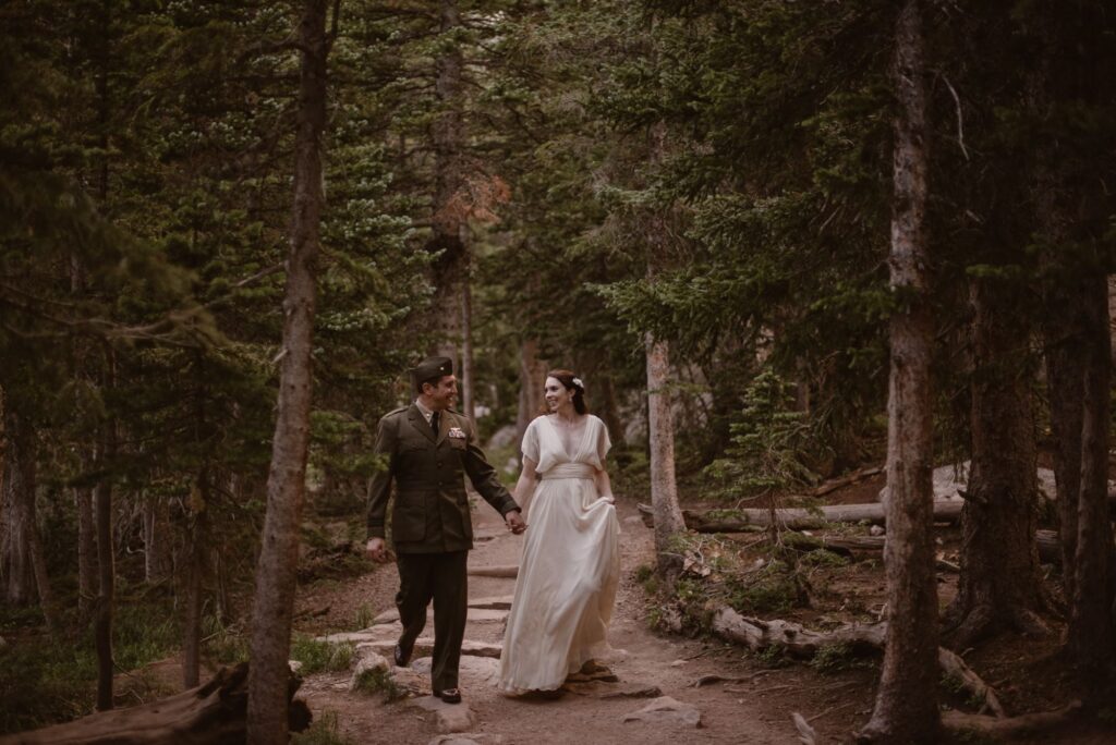 Couple hiking through the woods in their military attire