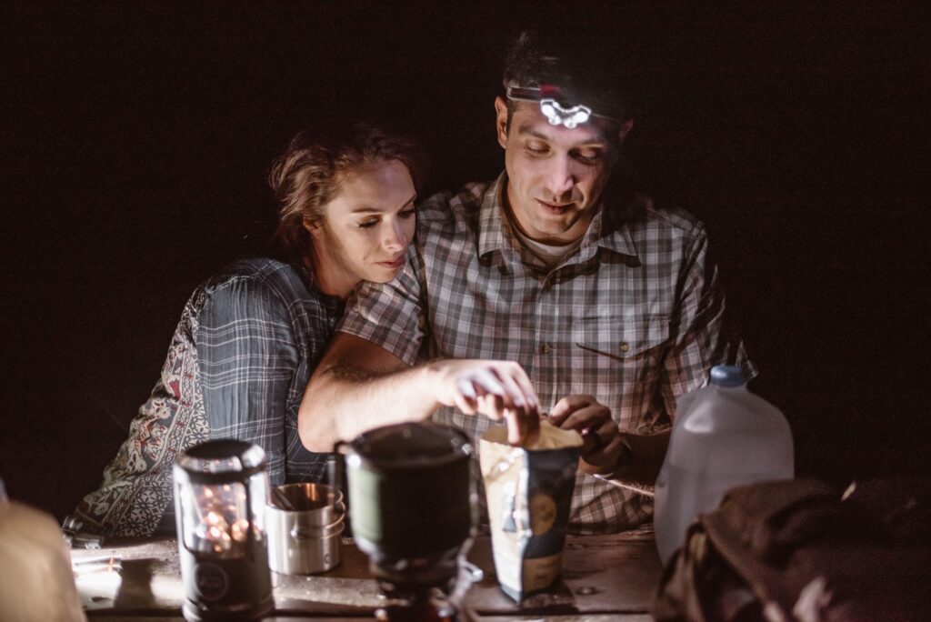 Couple cooking dinner over the fire on their wedding day