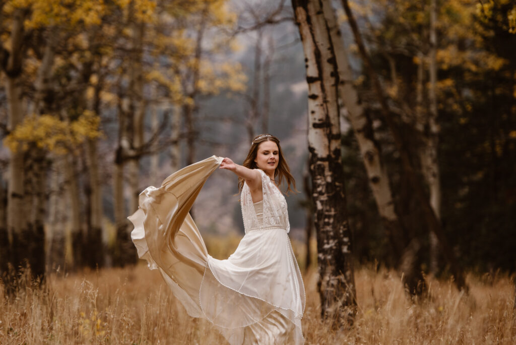 Bride twirling in a meadow in her wedding dress