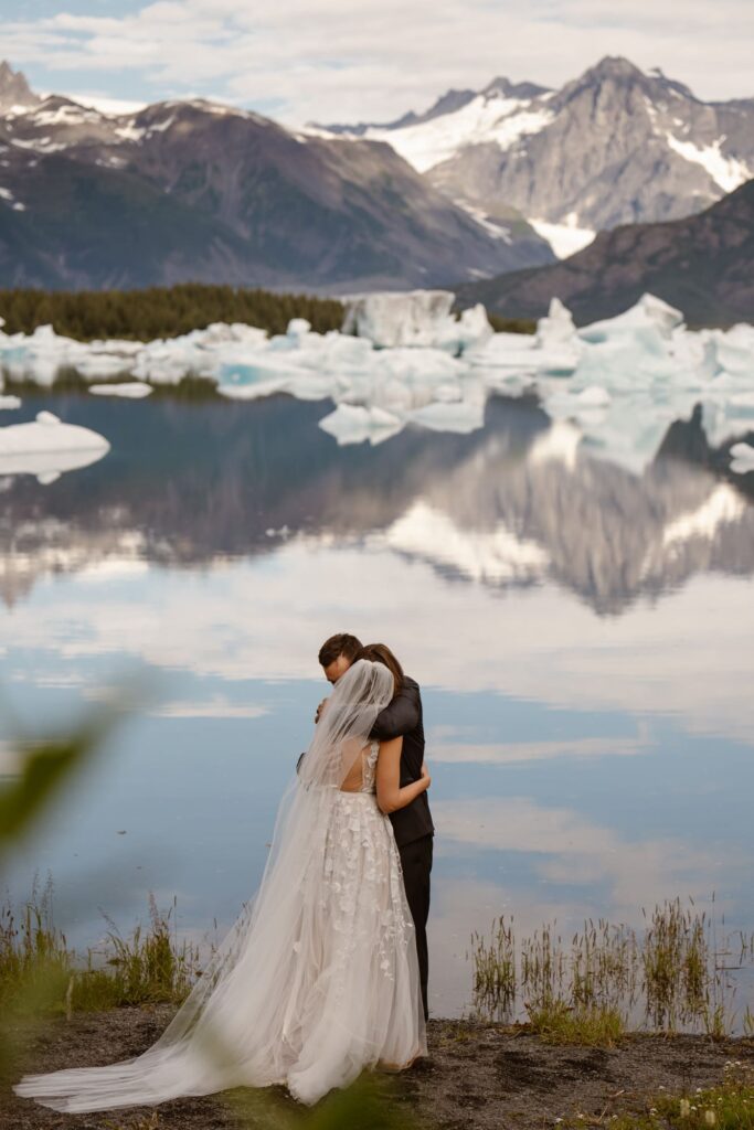 Bride and groom hugging during Alaska helicopter elopement