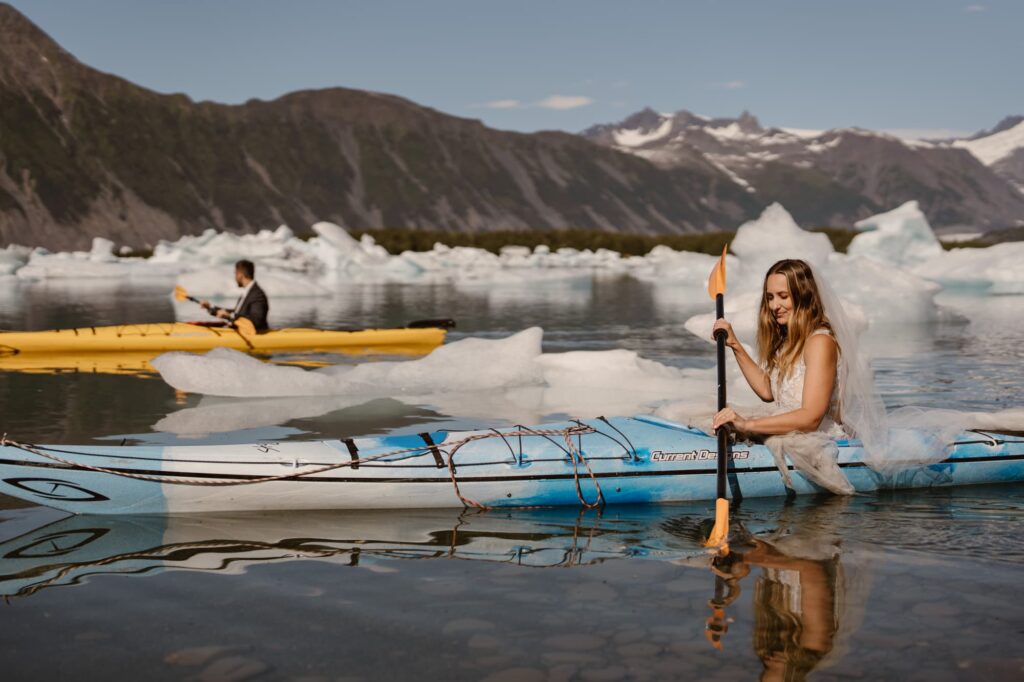 Bride and groom kayaking at Bear Glacier in Alaska