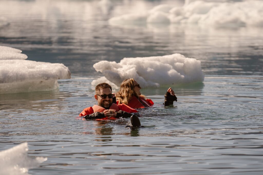 Couple floating in glacier water on their wedding day