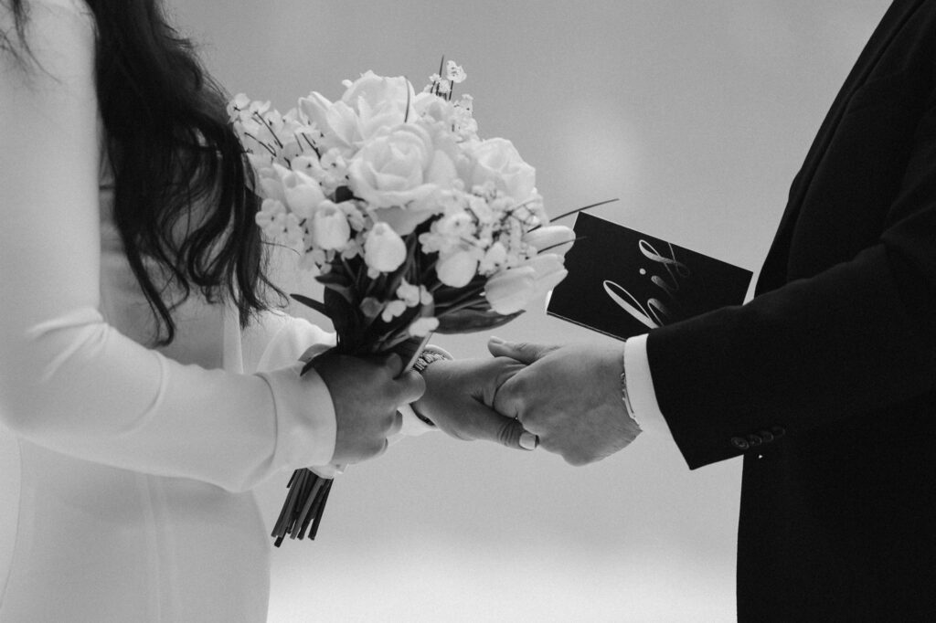 Couple holding hands while getting married