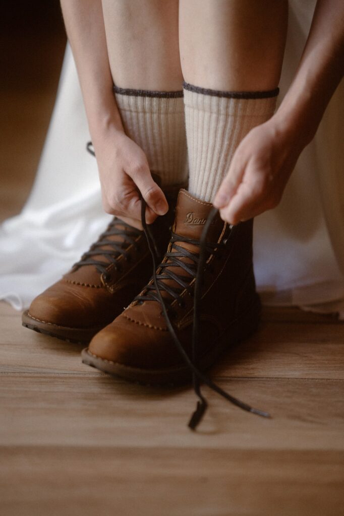 Bride lacing up hiking boots