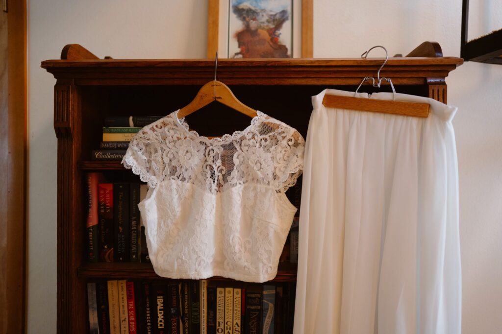 Two piece wedding dress on a bookshelf