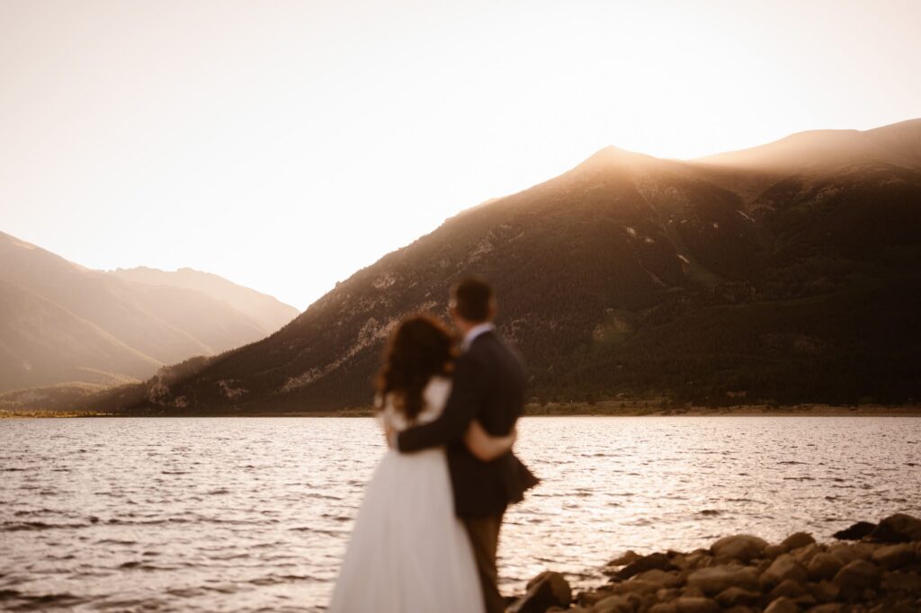 Bride and groom looking at the mountains during their adventure elopement