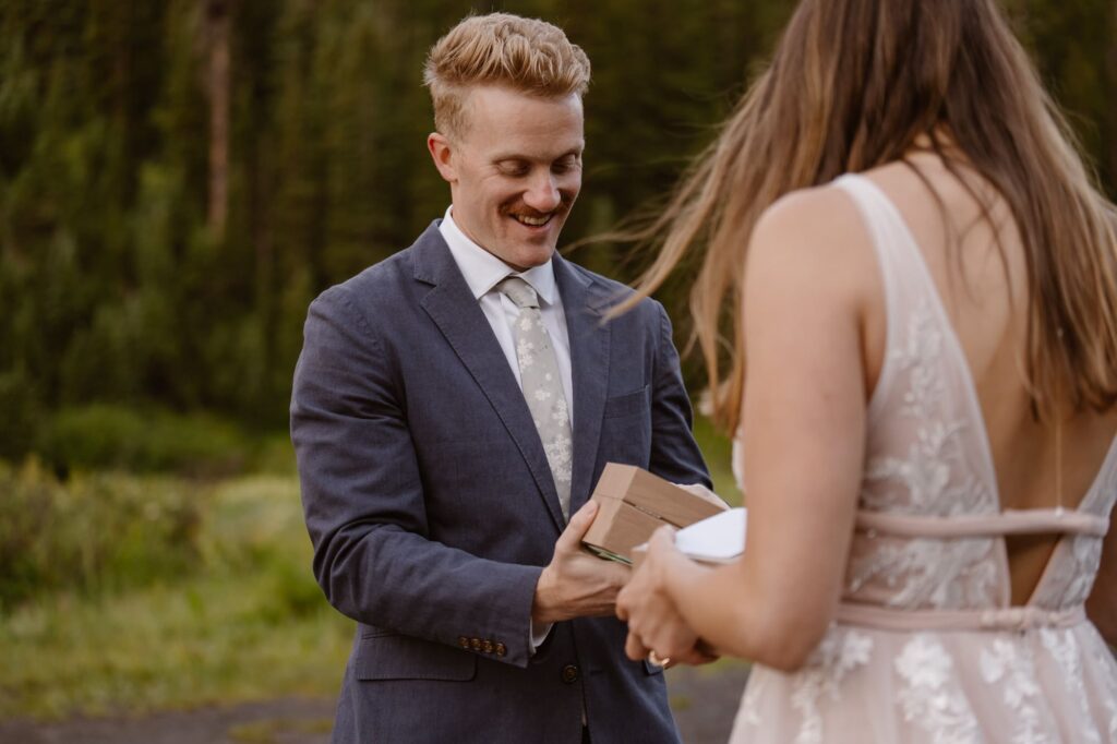 Groom smiling at wedding day gift