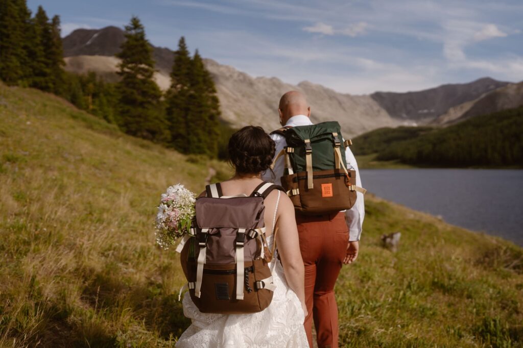 Couple hiking with Topo backpacks on their wedding day