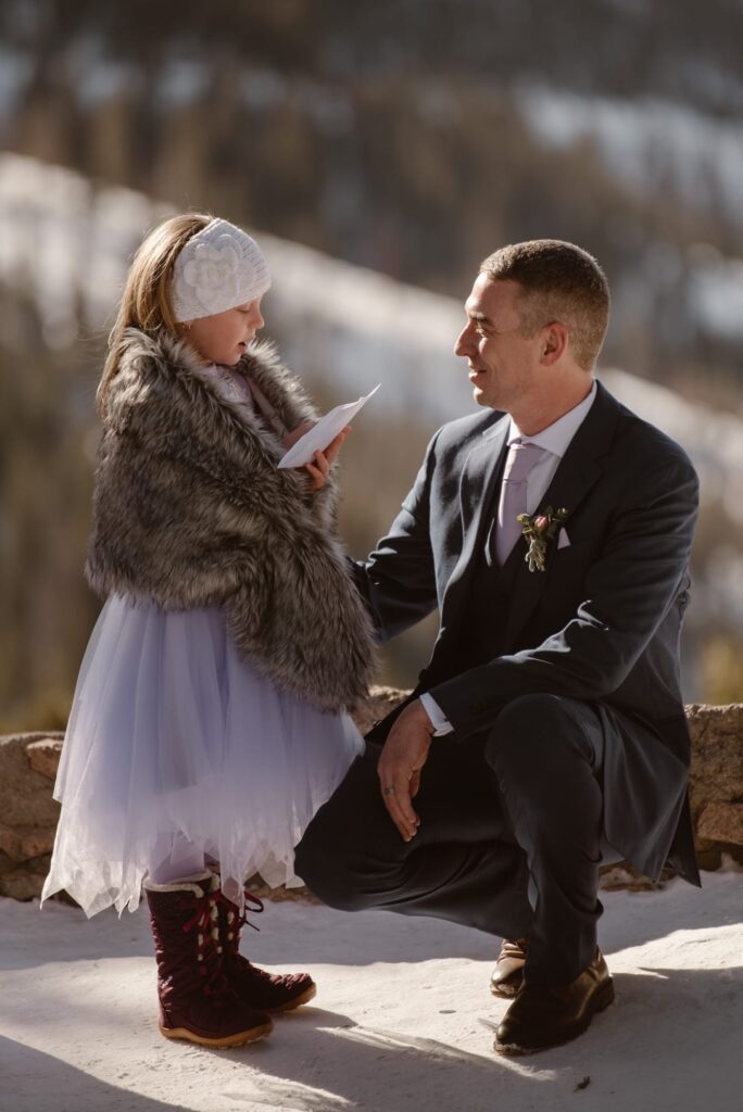 Little girl reading letter during the wedding ceremony