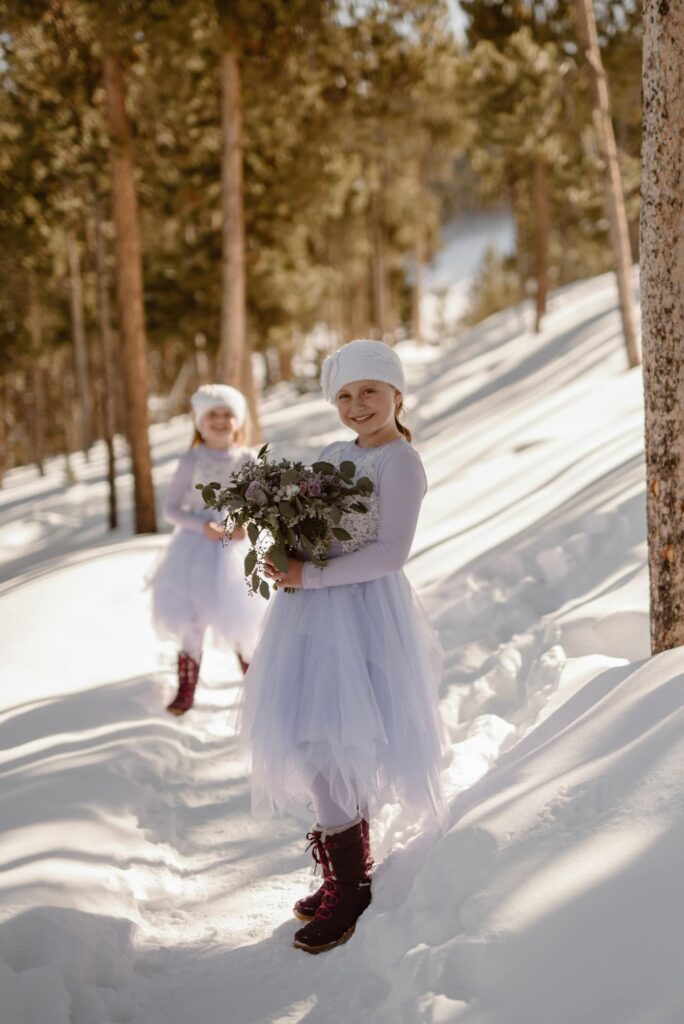Two girls posing in the snow with the bouquet