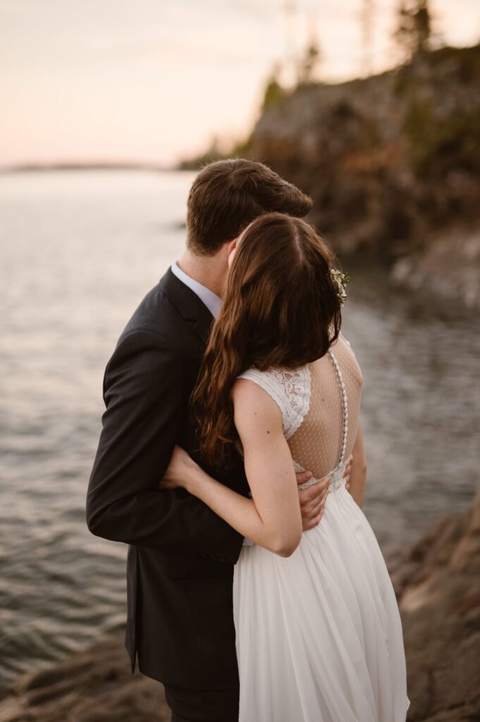 Couple snuggling in the sunset on their elopement day