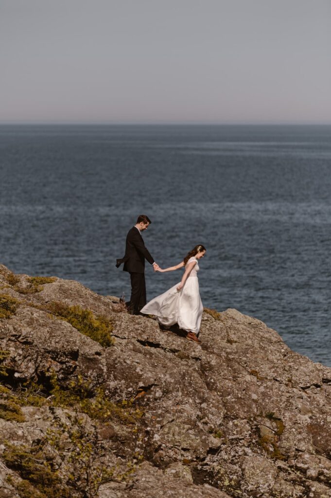 Bride and groom walking along the lakeshore