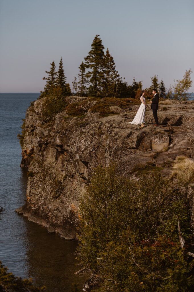 Couple on a rocky cliff at Isle Royale National Park on their elopement day