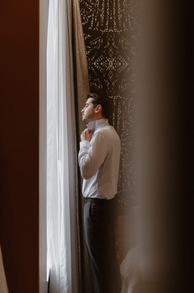 Groom getting ready in The Vault hotel in Houghton, Michigan