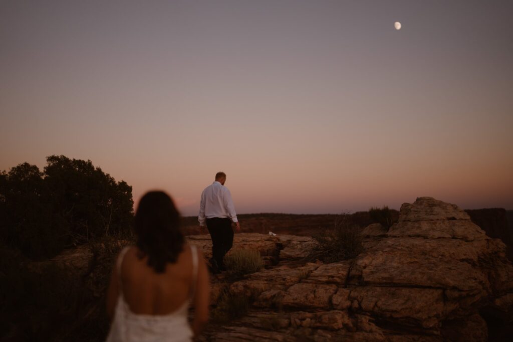 Couple walking off into the sunset on their Moab adventure elopement day