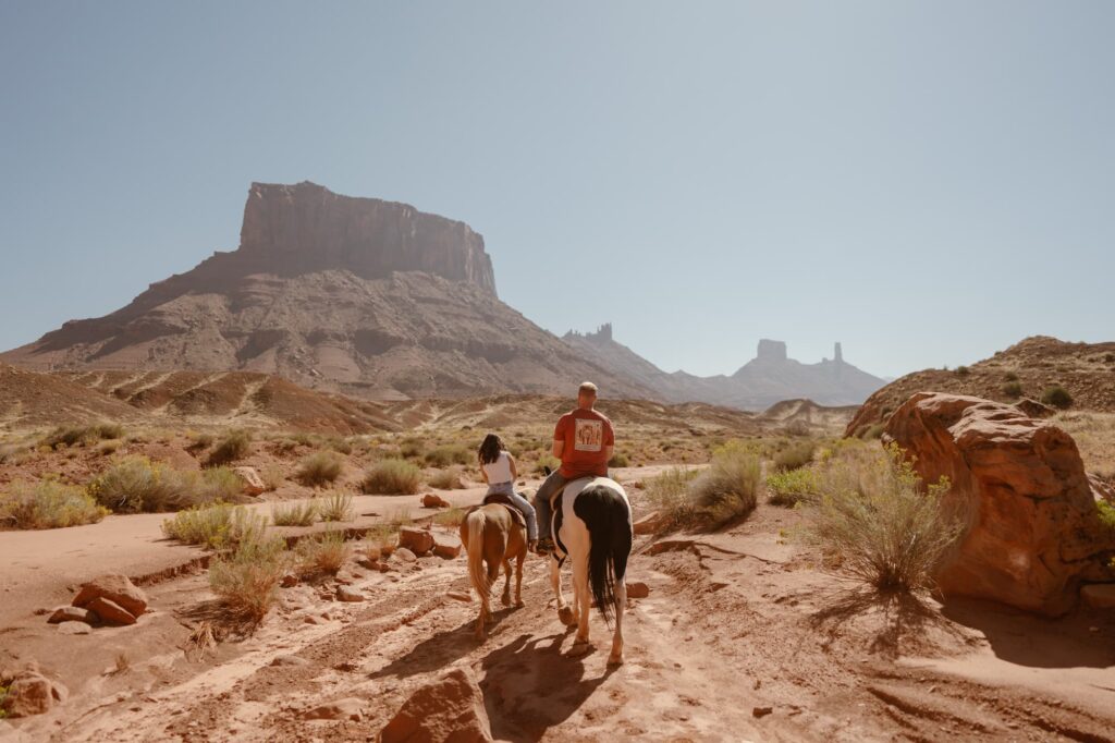 Couple horseback riding on their elopement day