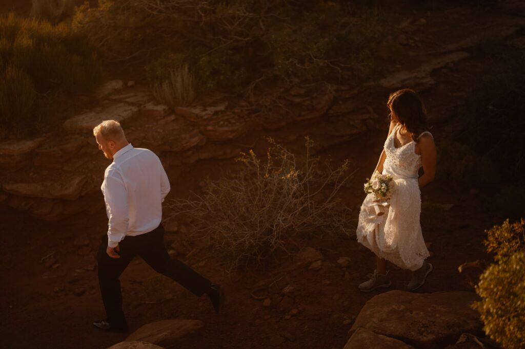 Couple hiking around cliffs on their elopement day