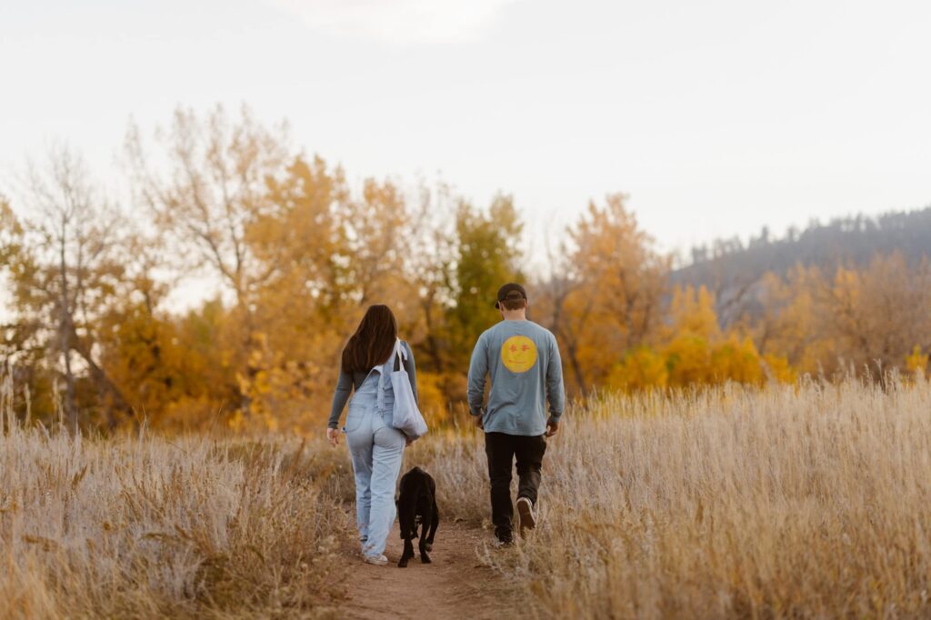 Couple walking off into the distance with their dog