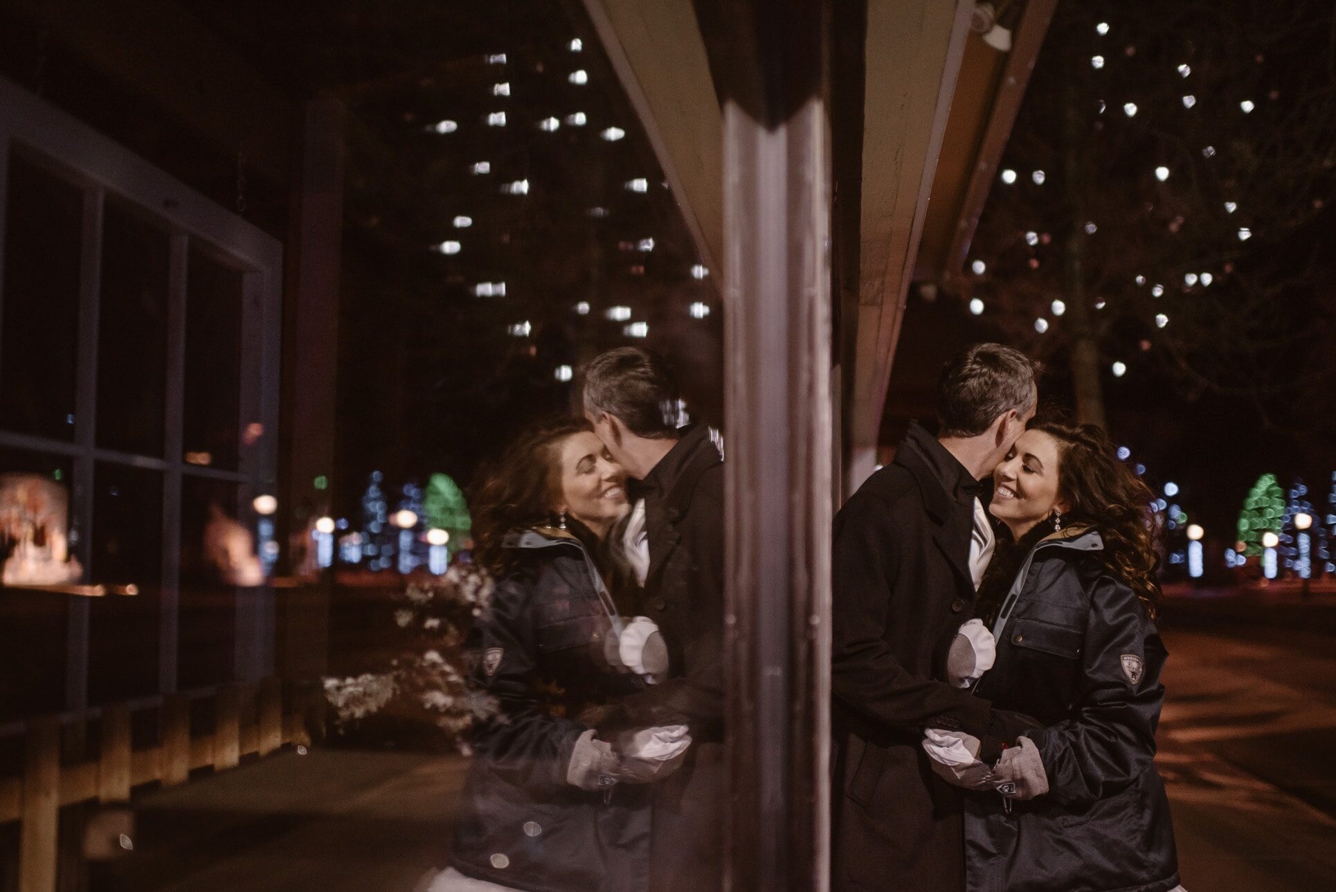 Couple under the sparkling lights in downtown Estes Park on a date night
