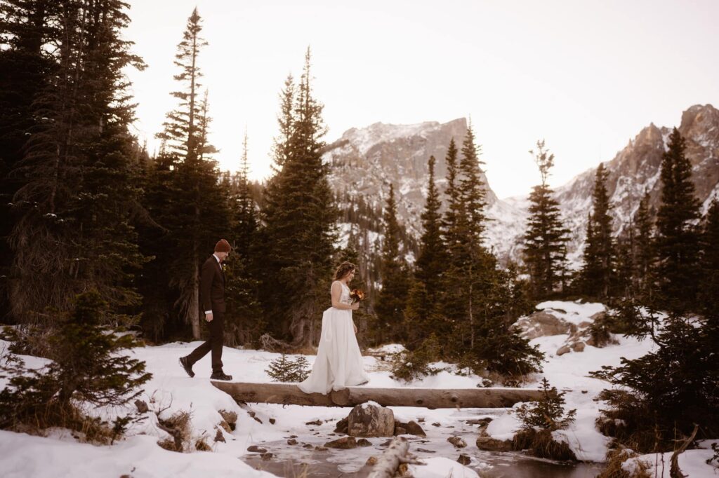 Bride and groom hiking to Dream Lake on their elopement day