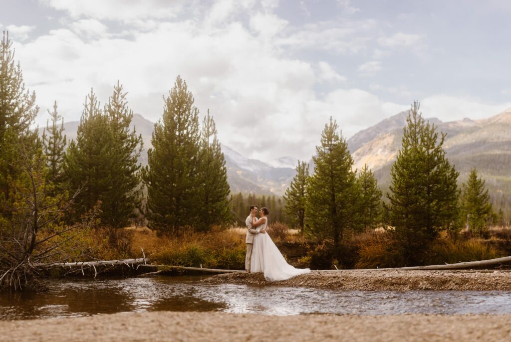 Bride and groom along the river in Grand Lake, Colorado