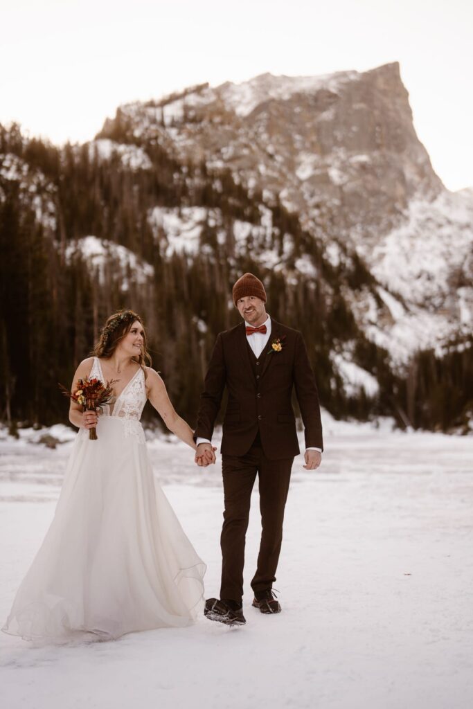 Couple walking and laughing at Dream Lake on their elopement day