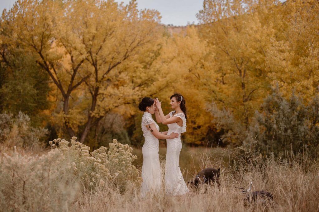Wedding couple in the yellow fall foliage at their Ghost Ranch wedding in October