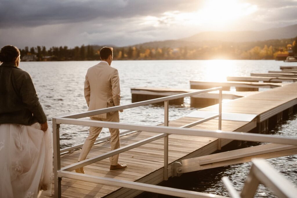 Bride and groom on a lake dock on their wedding day