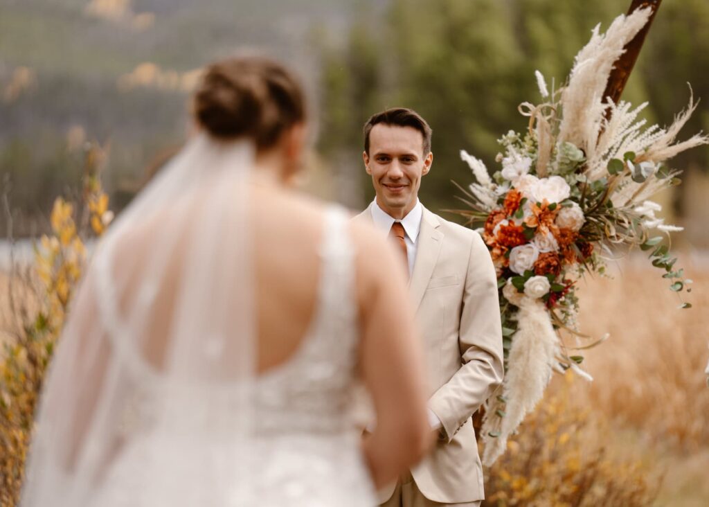 Groom seeing his bride walk down the aisle for the first time