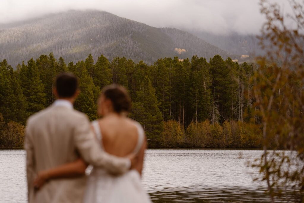 Couple looking out into the mountains and lake during their wedding