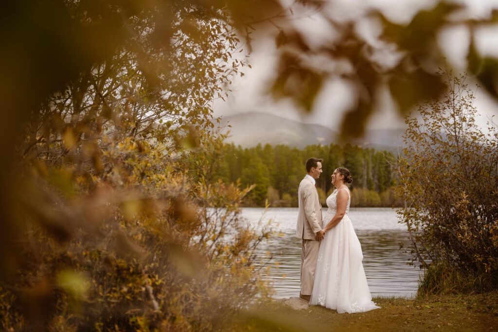 Couple on the lakeshore of Grand Lake, Colorado during their wedding