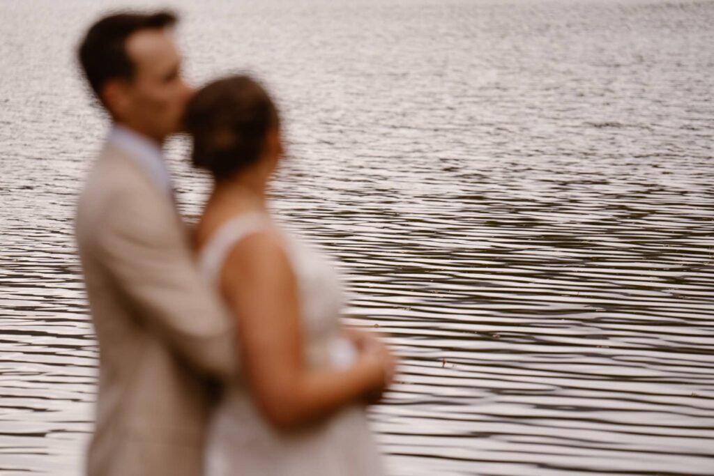 Couple looking out onto Grand Lake on their wedding day