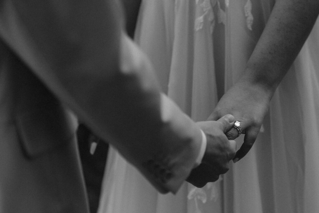 Close up of holding hands and wedding rings