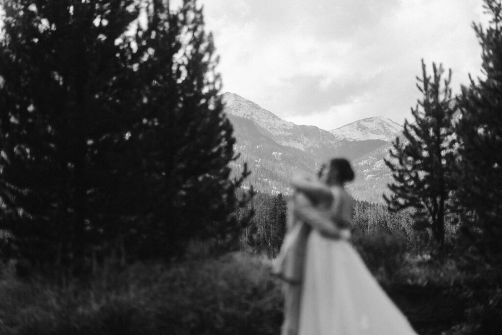 Couple hugging in the mountains on their wedding day