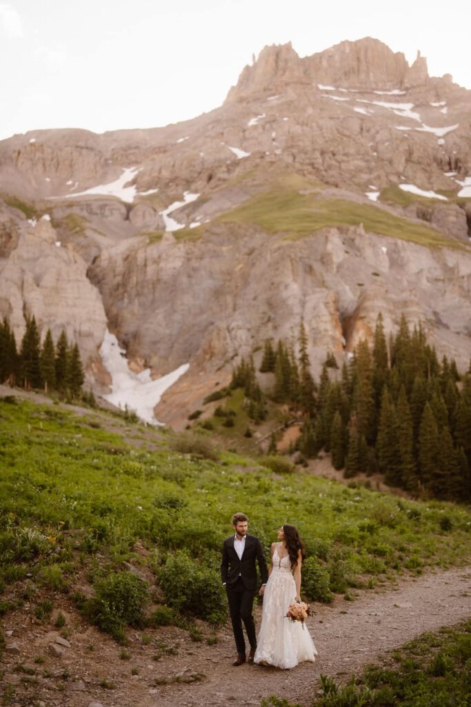 Bride and groom taking portraits in Ouray, Colorado