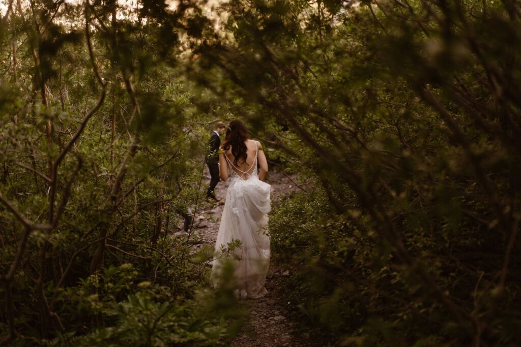 Bride walking through the woods in her wedding dress