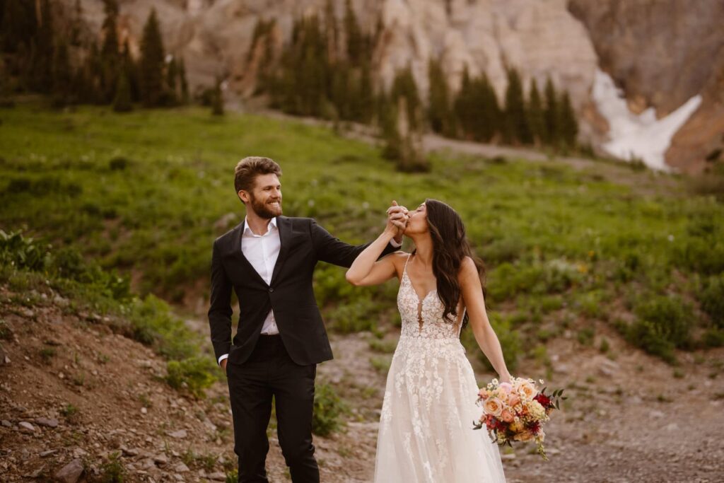 Bride kissing grooms hand