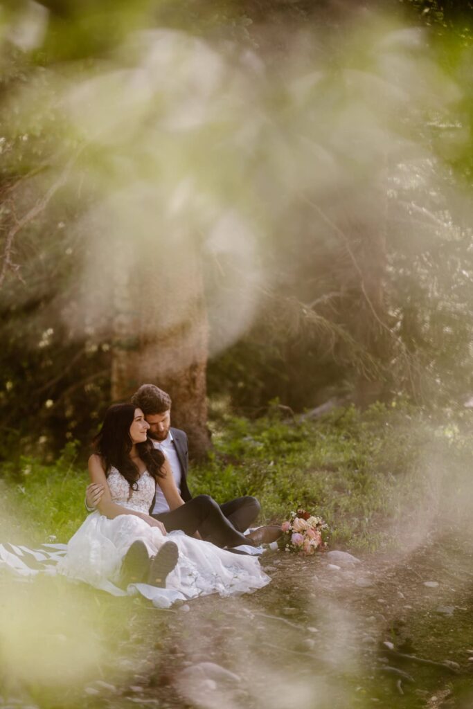 Couple laying on a picnic blanket on their wedding day