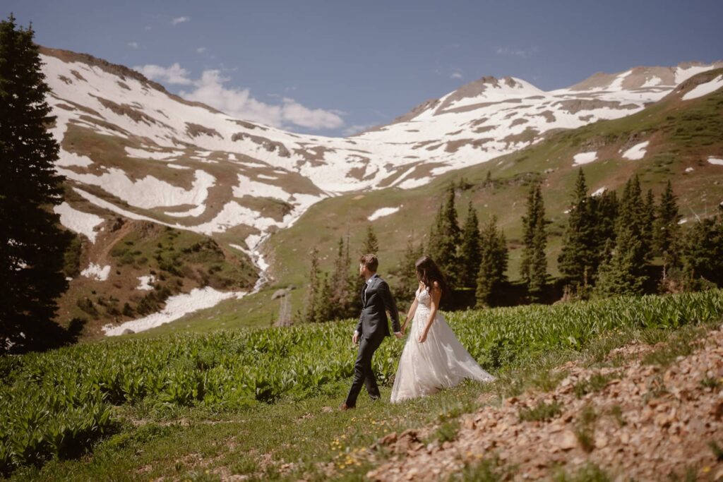 Couple walking through the mountains of Ouray, Colorado during their destination wedding