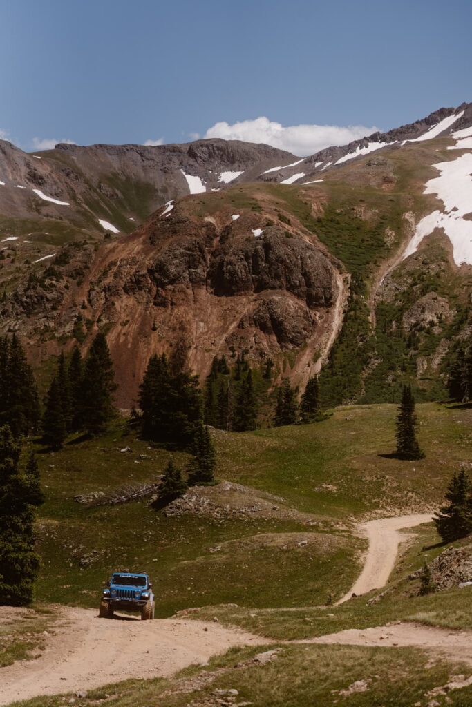 Jeep driving up a dirt road in Colorado