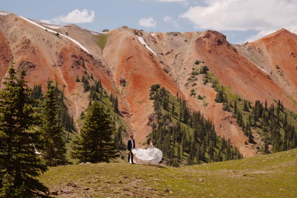 Bride dancing in the mountains with her groom during their small destination wedding in Colorado