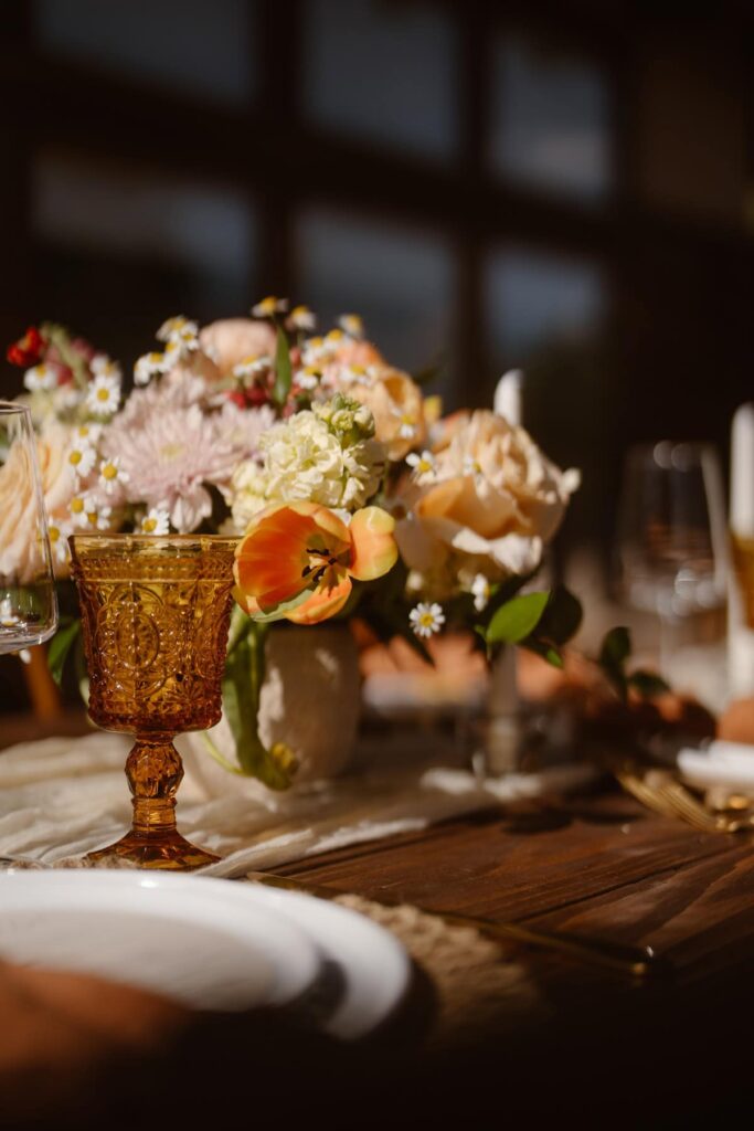 Flowers and antique goblets at romantic wedding meal