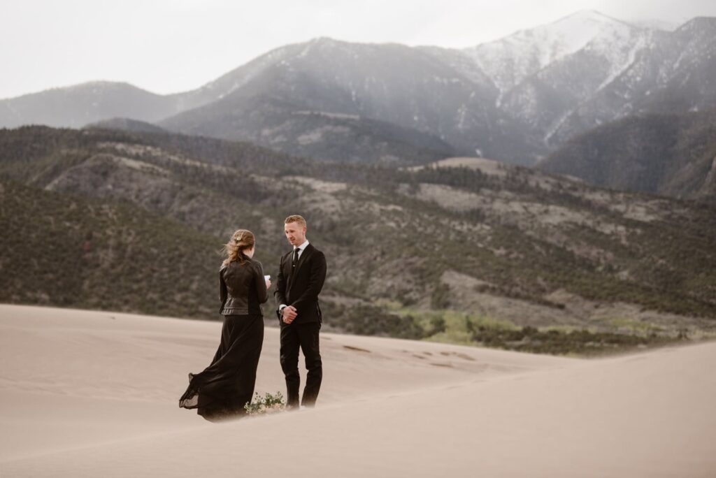 Bride and groom wearing all black having a wedding ceremony