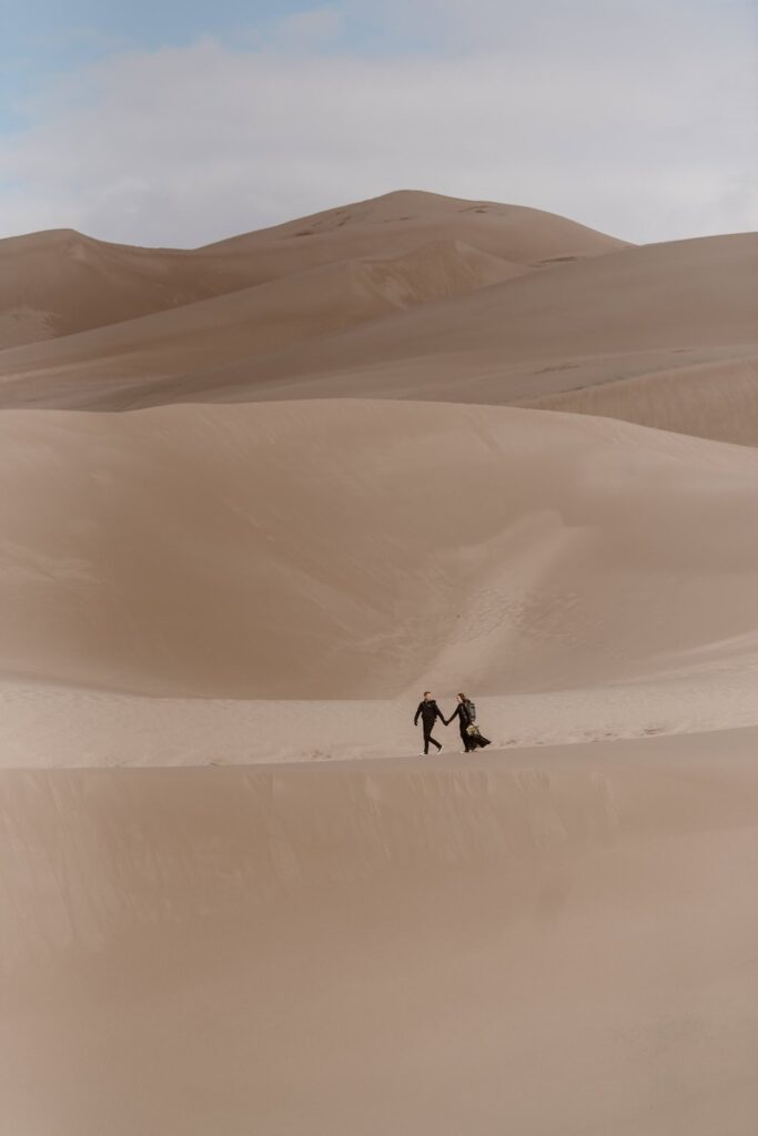 Bride and groom on the sand dunes in Colorado during their motorbike wedding