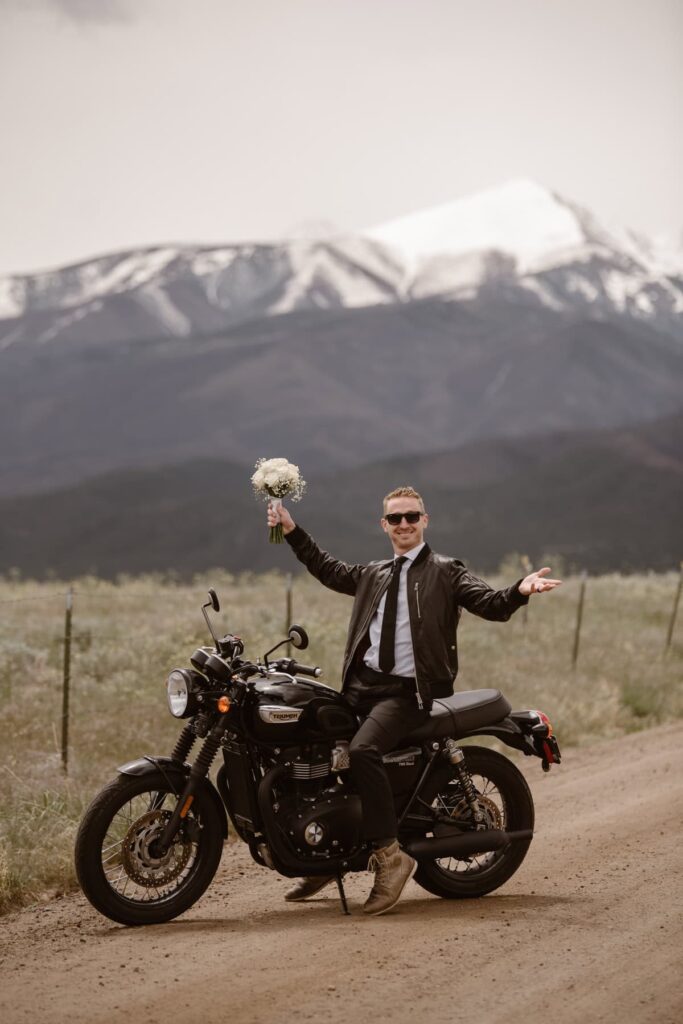 Groom on his Triumph motorbike during his wedding 